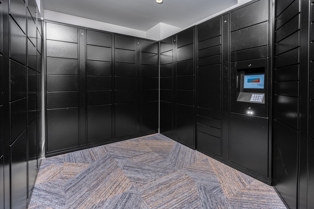 a row of black lockers in a room with a blue and yellow carpet