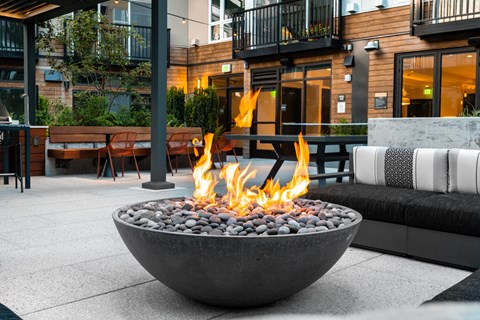 a fire pit on a patio in front of a building