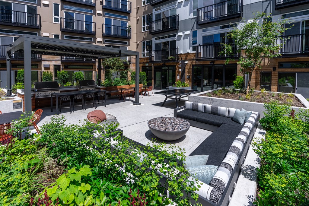 a courtyard with a couch and a fire pit