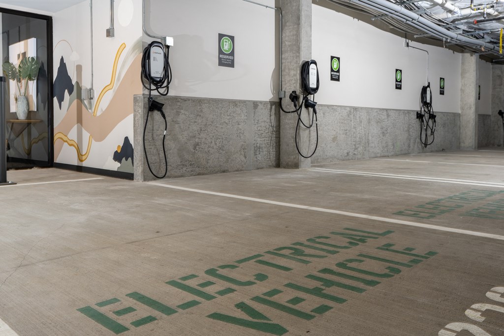 a large room with two charging stations and a wall with a mural on it