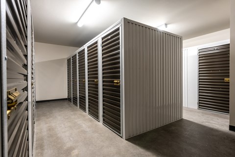 a large closet with shutters in a room with a concrete floor