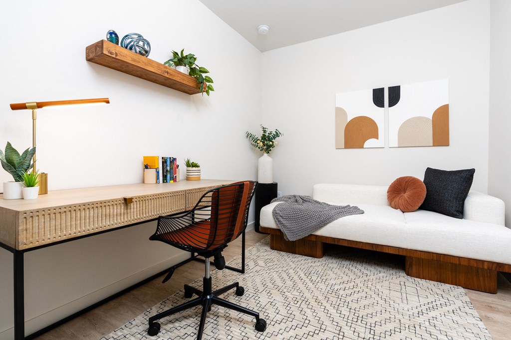 a bedroom with a bed and a desk with a chair