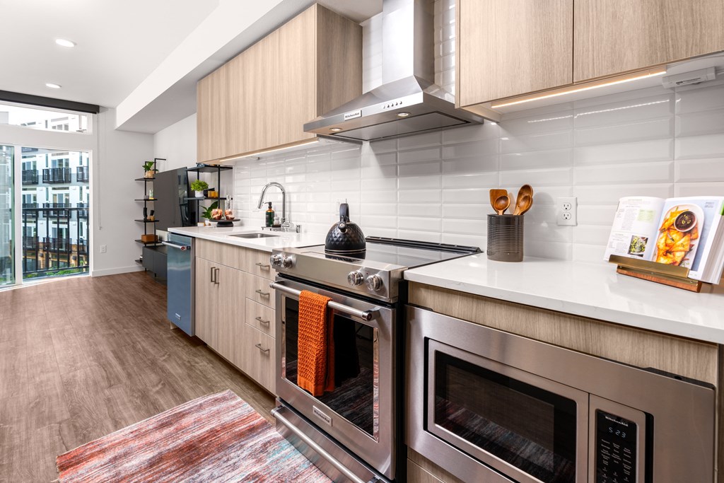 a kitchen with stainless steel appliances and white counter tops