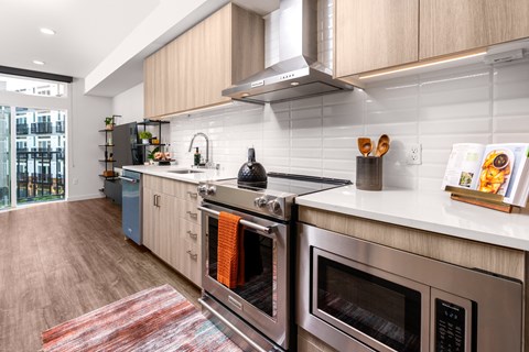 a kitchen with stainless steel appliances and white counter tops