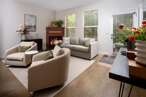 A living room with a fireplace and a painting on the wall.