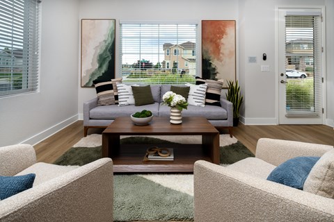 A living room with a couch, chairs, and a coffee table.
