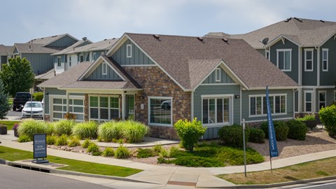 A row of houses with a sign in front of them.