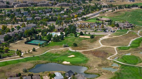 A golf course surrounded by houses.