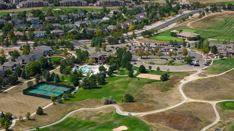 A view of a neighborhood with houses and a green field.