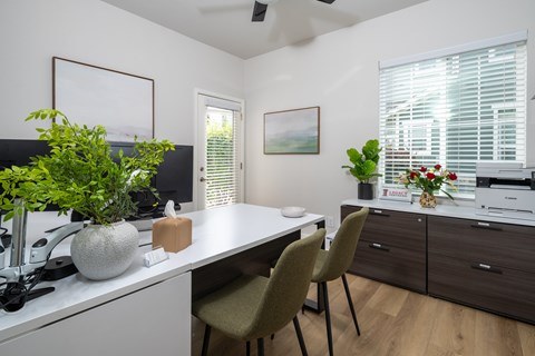 A white kitchen with a table and chairs.