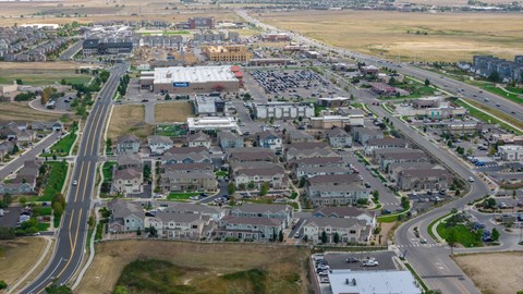 A suburban area with a large road and houses.