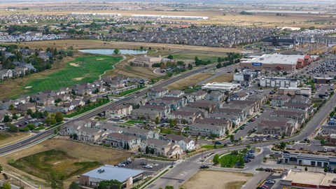 A suburban area with a mix of residential and commercial buildings.