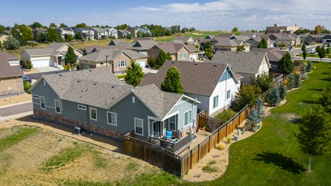 A row of houses with a blue house in the front.
