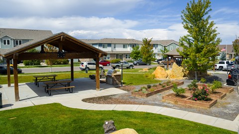 A park with a pavilion, picnic table, and a playground.