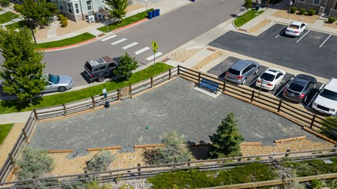 A playground with a slide and a basketball court.