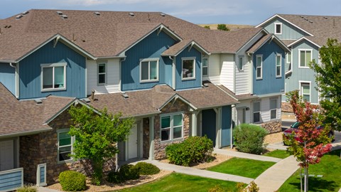A row of houses with blue and grey exteriors.