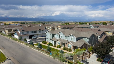 A suburban neighborhood with houses and a street.