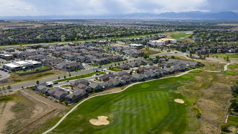 A golf course is surrounded by houses.