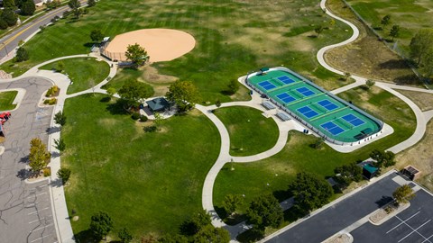 A park with a tennis court and a basketball court.