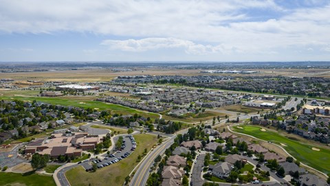 A suburban area with a mix of residential and commercial buildings.