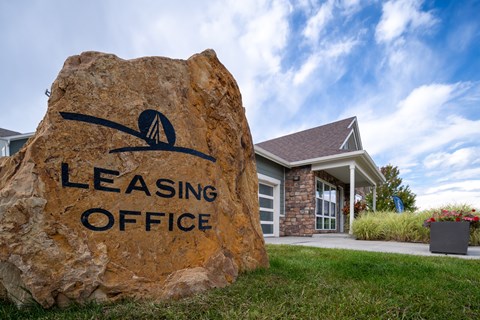 A large rock with the words "Leasing Office" carved into it.