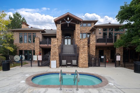 A large house with a pool in front.