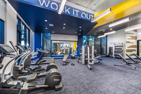 a gym with cardio equipment and weights at a work it out space