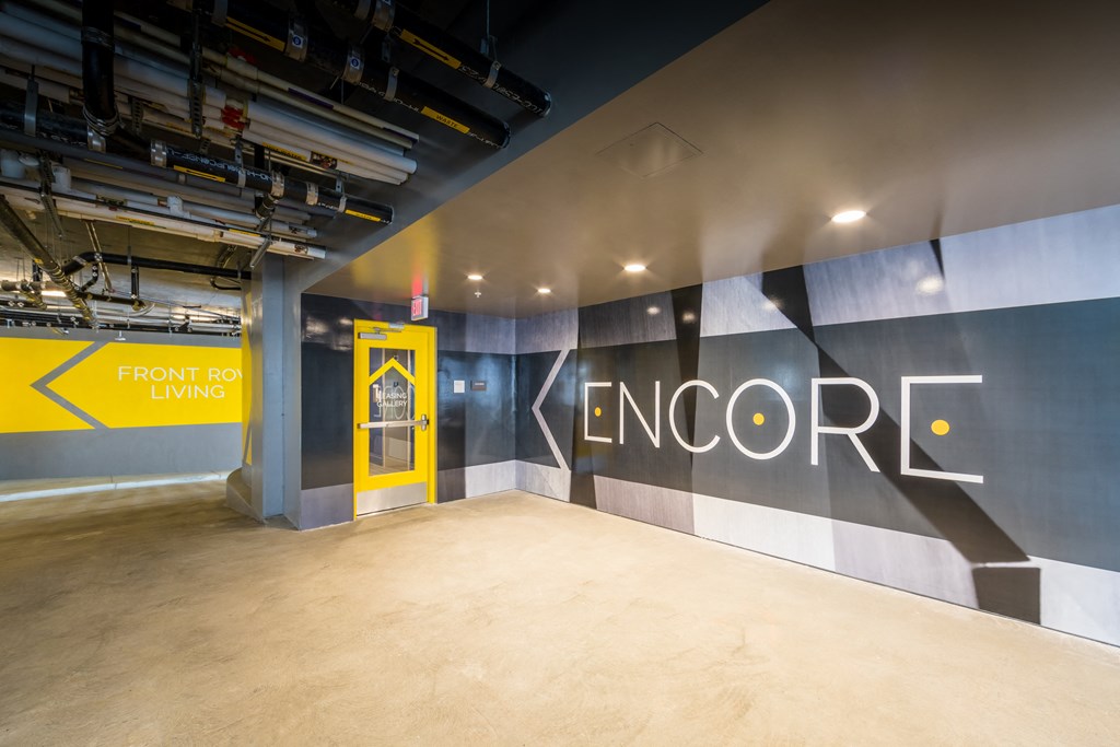 a large wall with a yellow door in the corner of a room