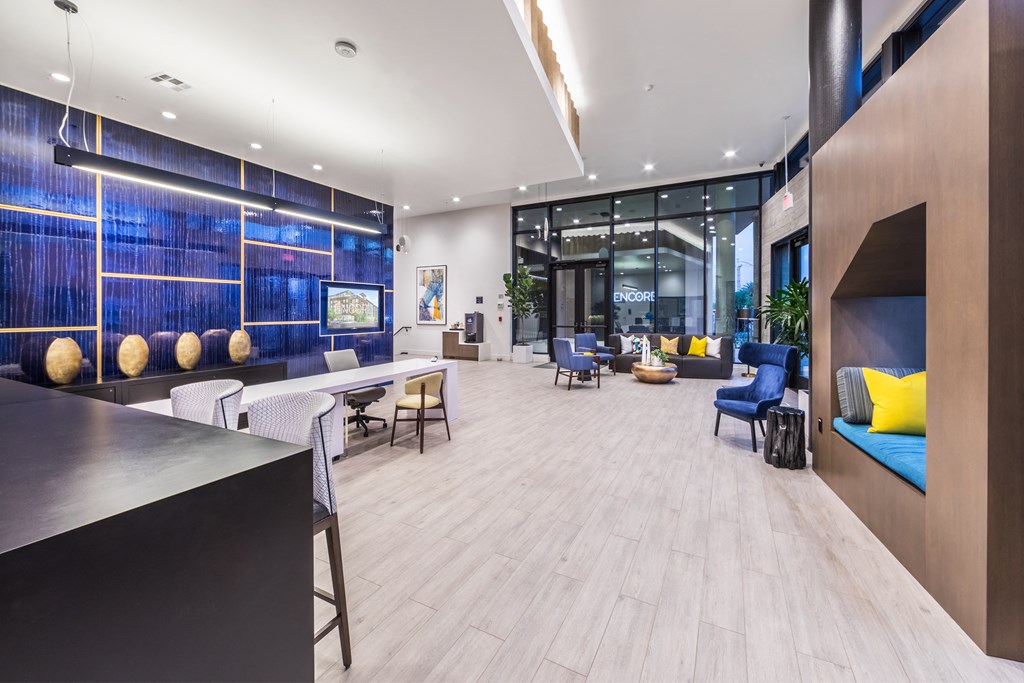 a lobby with blue and yellow furniture and a large window
