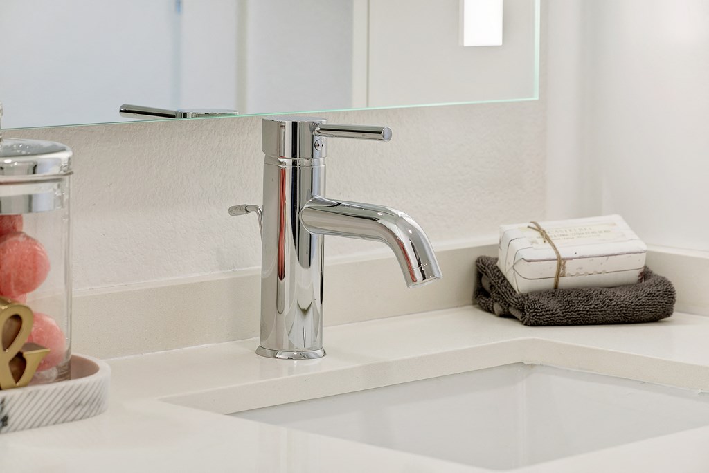 a white sink with a chrome faucet in a bathroom
