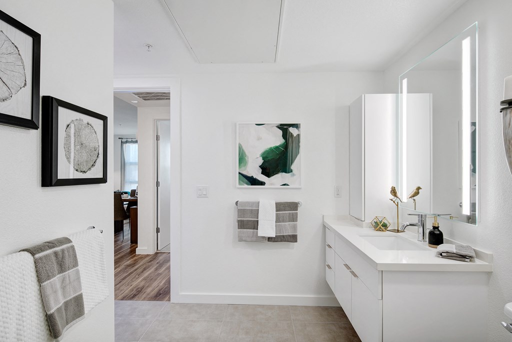 a white bathroom with a sink and a mirror