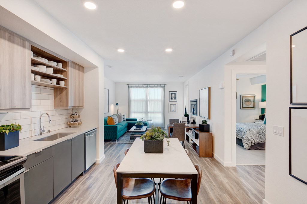 a living room with a kitchen and a dining table
