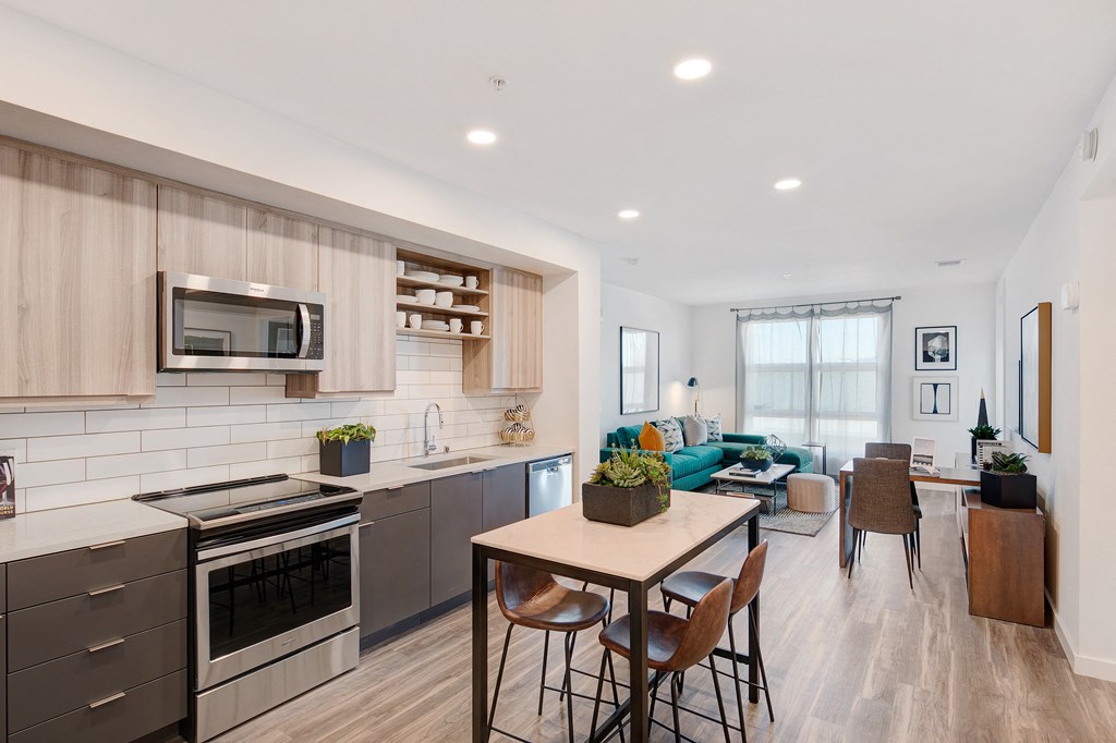 an open kitchen and living room with a table and chairs