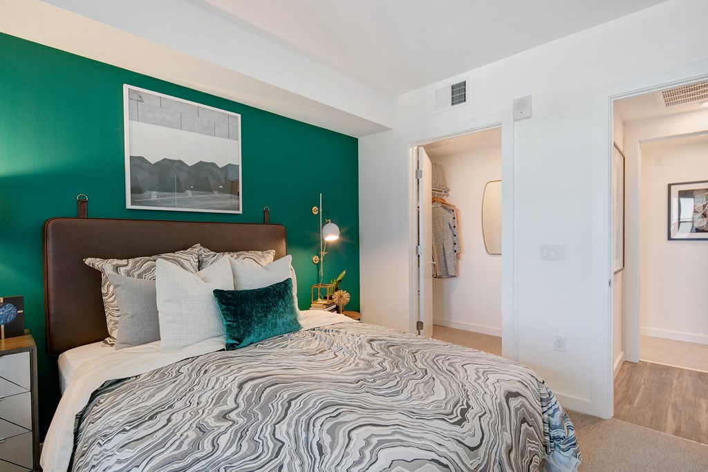 a bedroom with a green wall and a bed