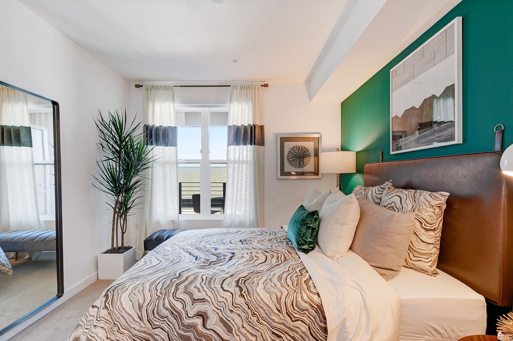 a bedroom with a large bed and a window