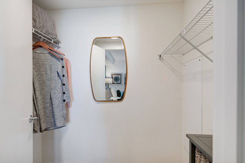 a mirror hanging on a wall next to a closet