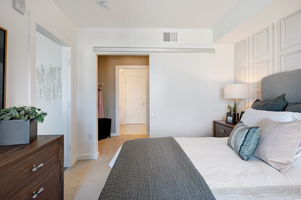 a bedroom with a large bed and a closet