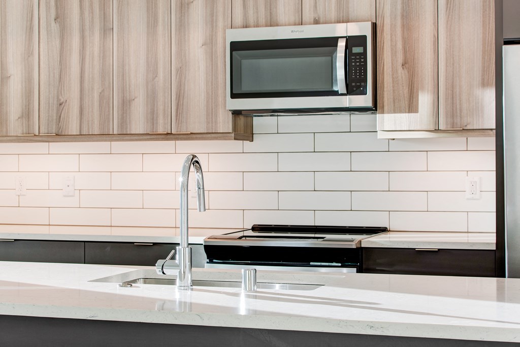 a kitchen with a sink and a microwave