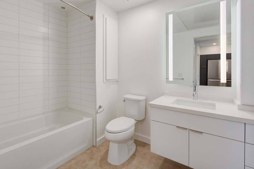 a bathroom with a toilet and a sink and a tub