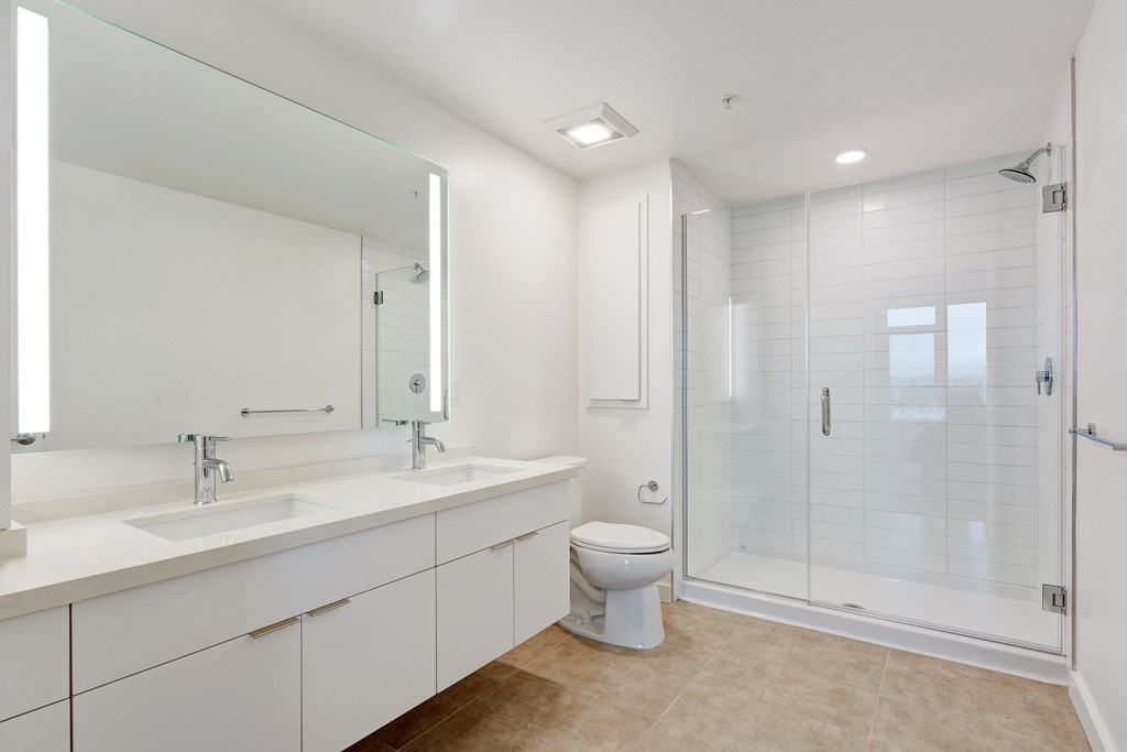 a bathroom with a toilet sink and a shower