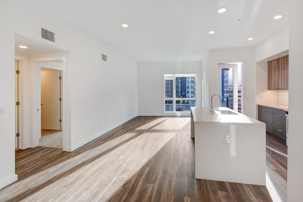 a white kitchen with a large island in the middle