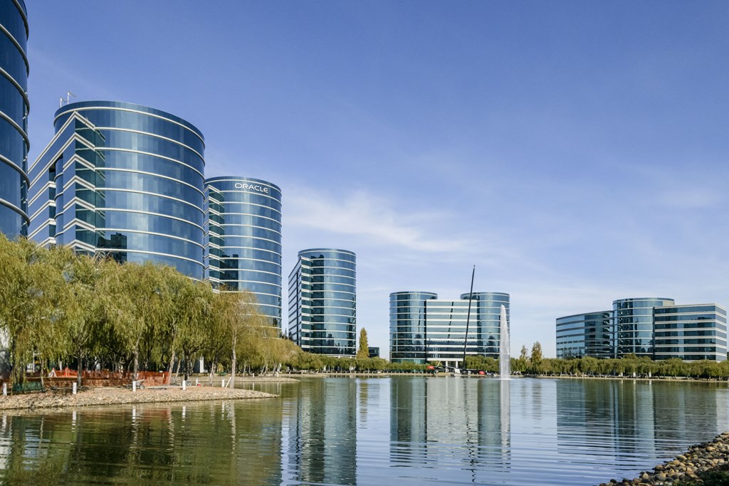 a row of tall buildings next to a body of water