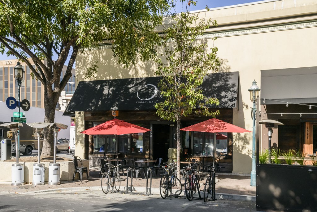 the front of a restaurant with bikes parked in front of it