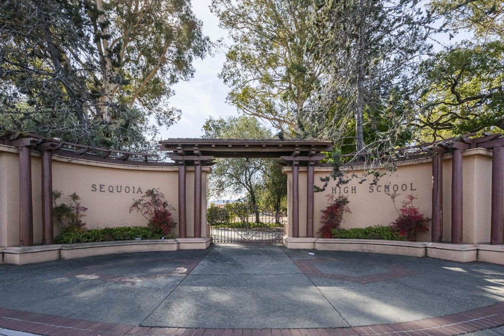 the entrance to seclusion high school with trees and a gate