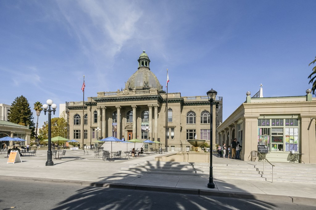 a large building with pillars and a dome in the middle of a city square