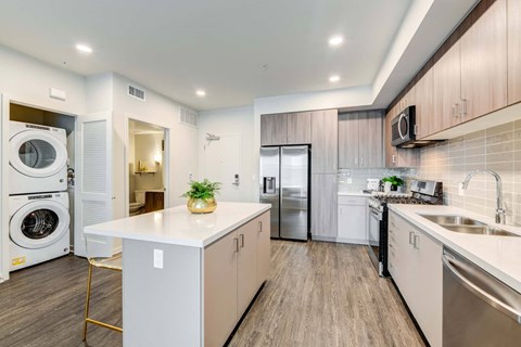 a kitchen with a washing machine and a sink