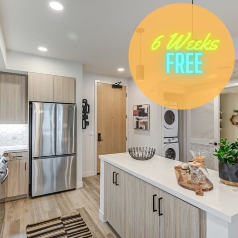 a kitchen with a refrigerator and a counter with a sign that reads 6 weeks free