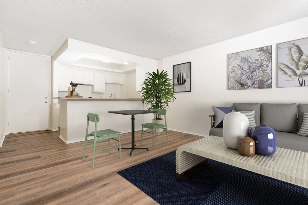 A living room with a couch, chairs, and a table.