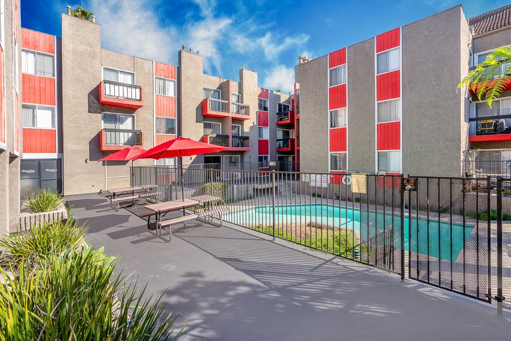 our apartments have a pool and a patio with tables and umbrellas