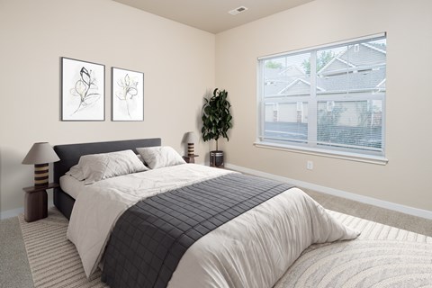 A bedroom with a large bed and two framed pictures on the wall.